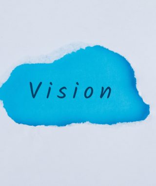 Marketing concept with vision word on blue and white background flat lay.